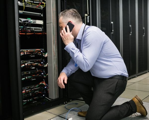 ASI - A man checking the server while talking someone with his phone ASI - A man checking the server while talking someone with his phone